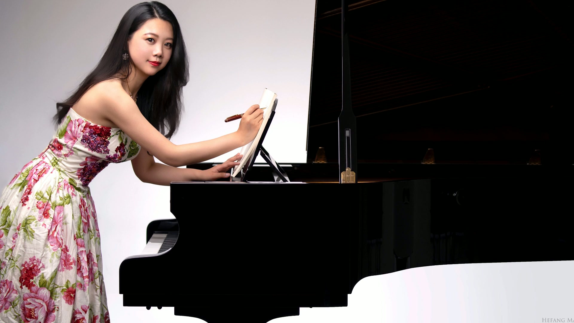 Hefang Ma beside a grand piano